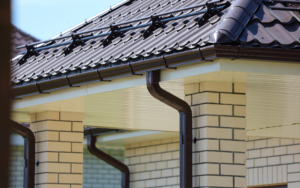 Brown Metal Gutter On The Roof Of The House