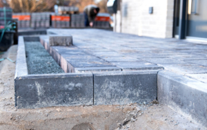 Construction Site Featuring Newly Laid Gray Concrete Pavers Forming A Patio Area